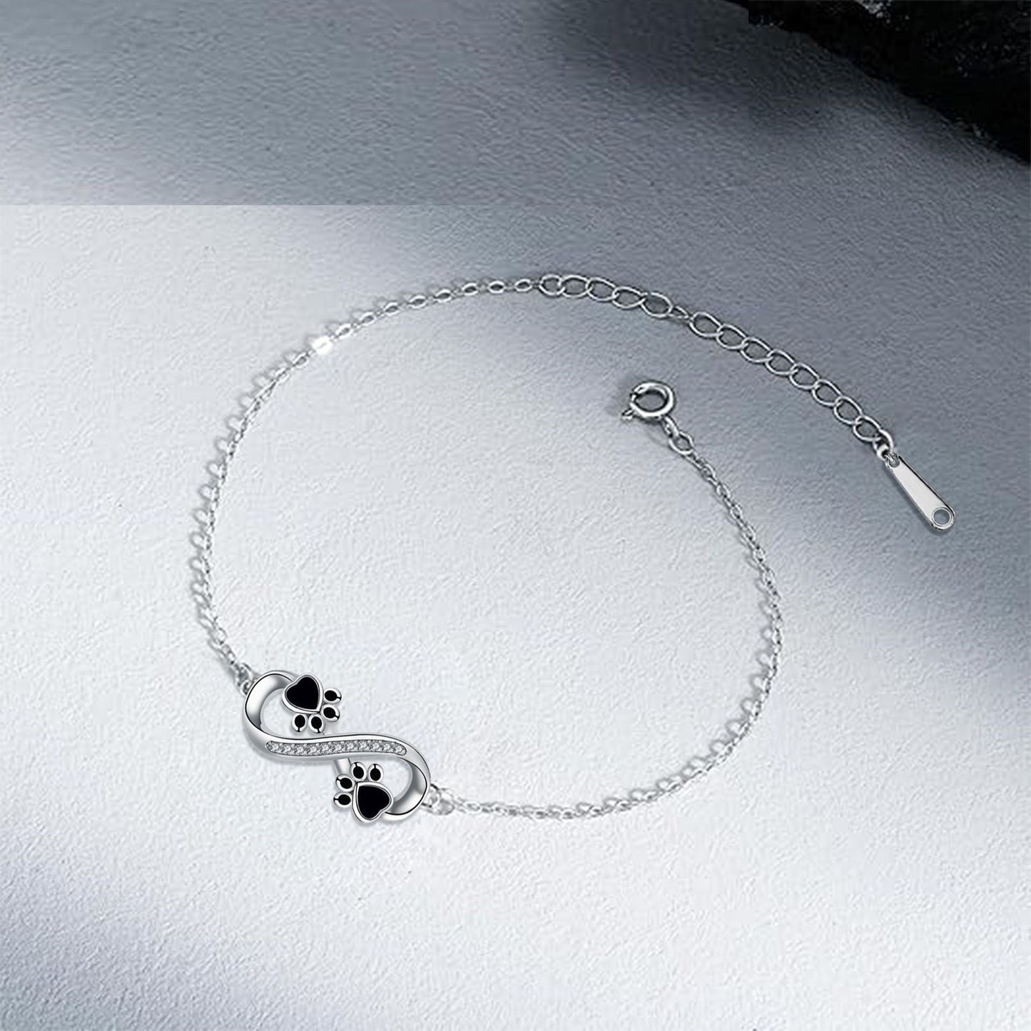 Pulsera con colgante de pata de mascota y símbolo de infinito con circonita cúbica